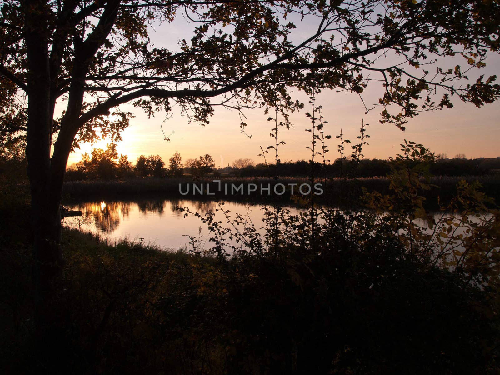 Beautiful dramatic sunset over a small countryside rural lake