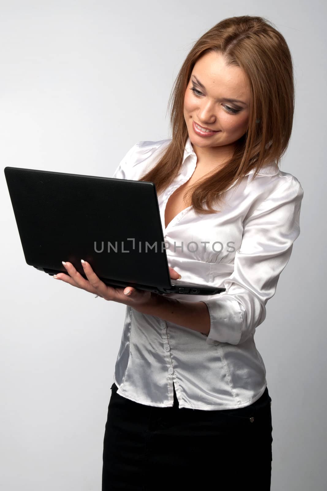 Young and beautiful girl in a light shirt with a black notebook in hand