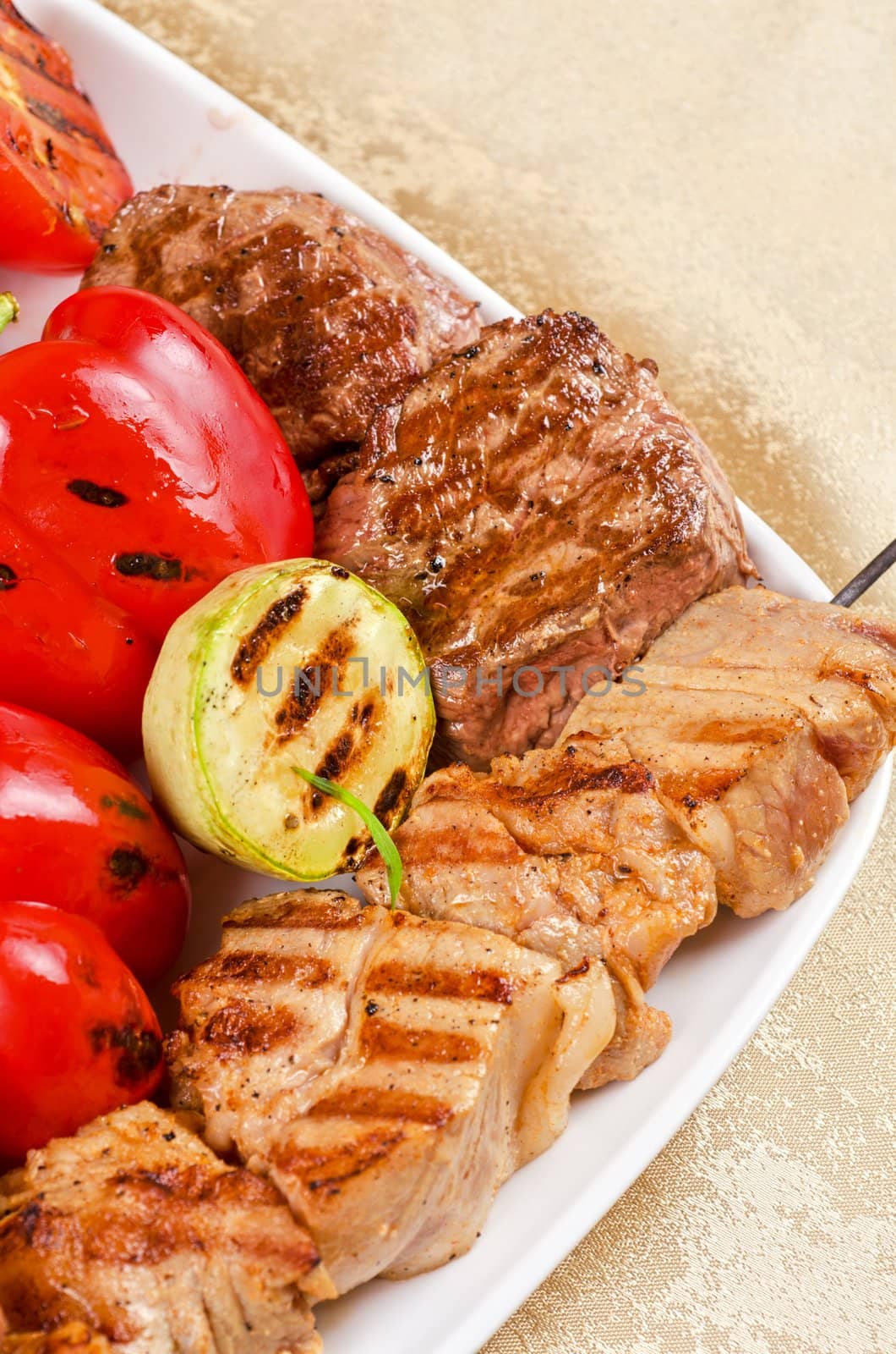 BBQ meat with vegetables and greens closeup