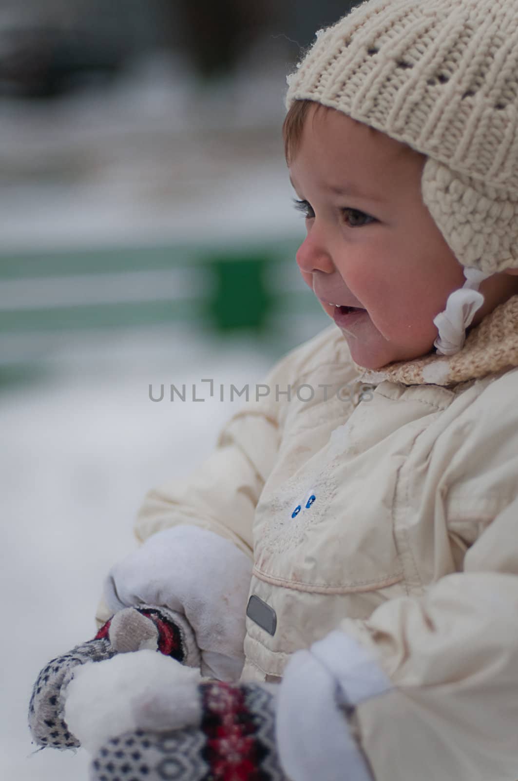 Little girl plays with snowball