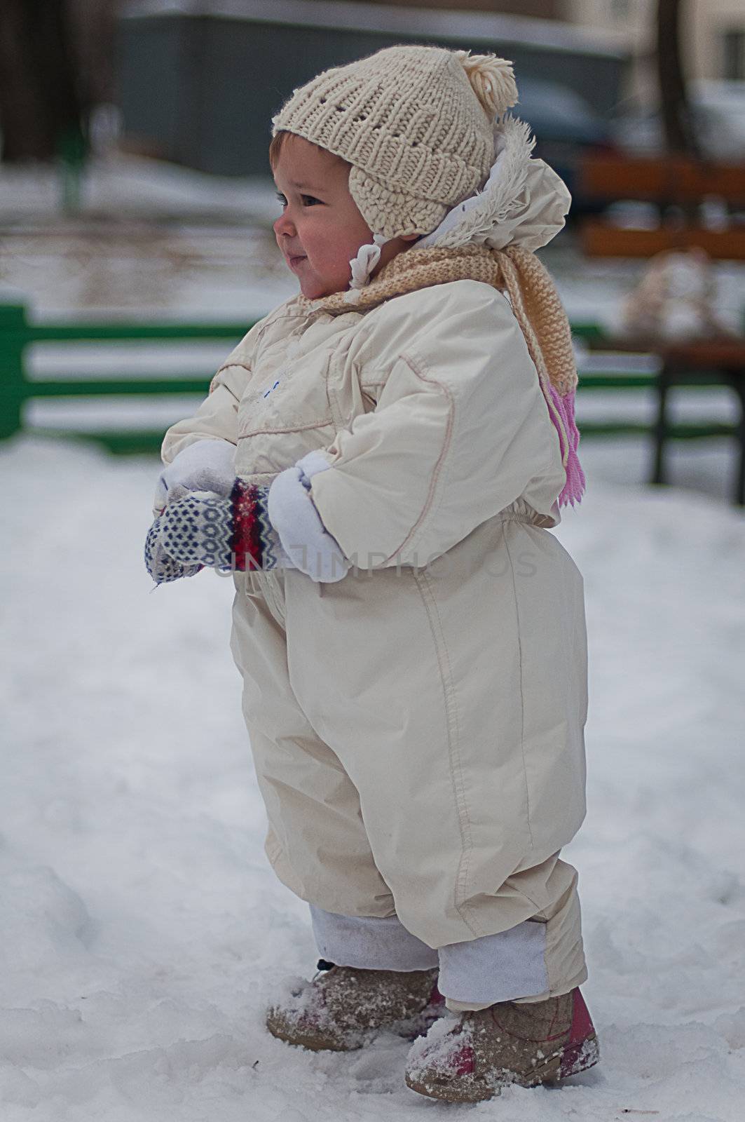 Little girl plays with snowball by Linaga