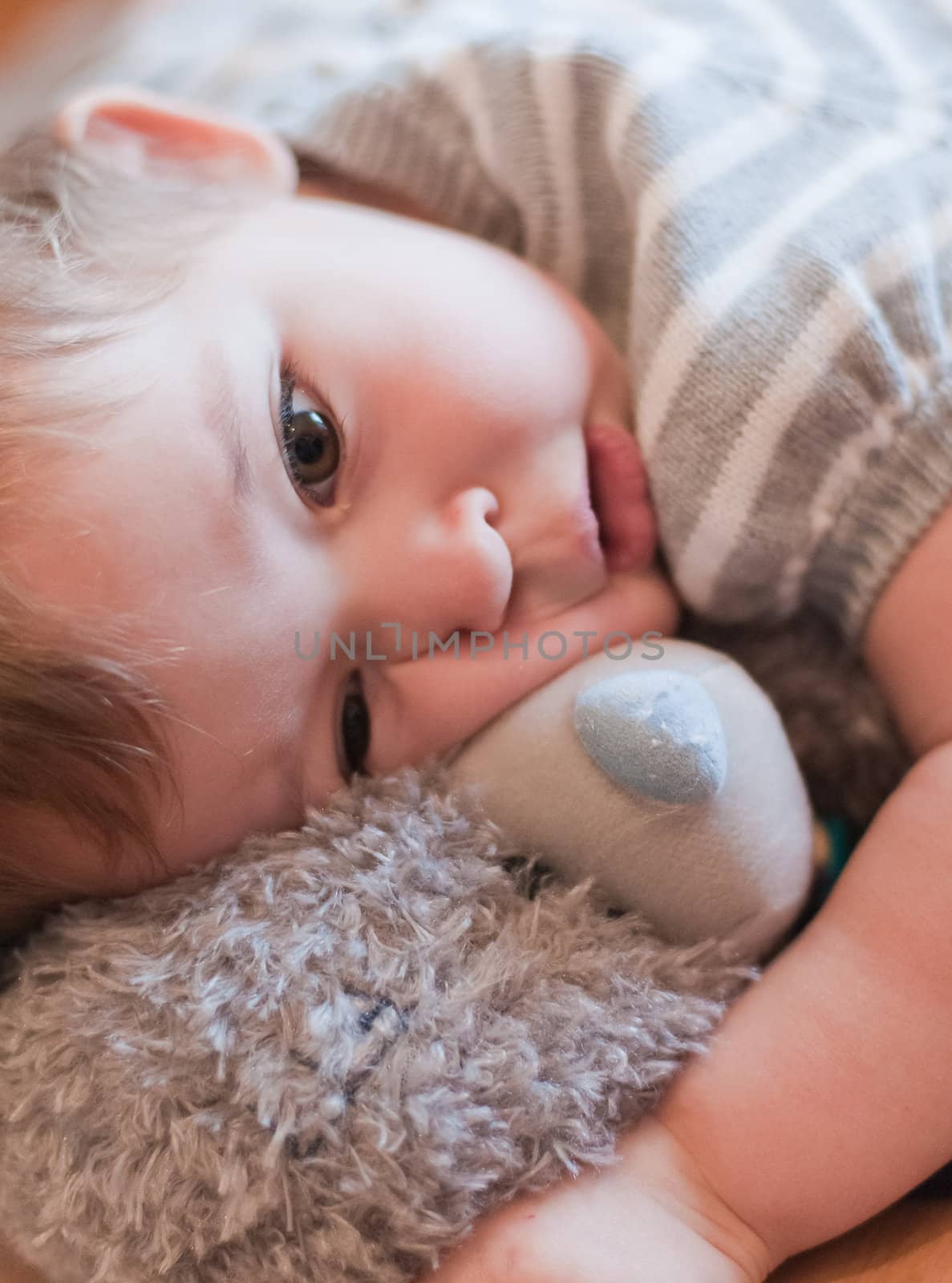 Little girl hugs her teddy bear