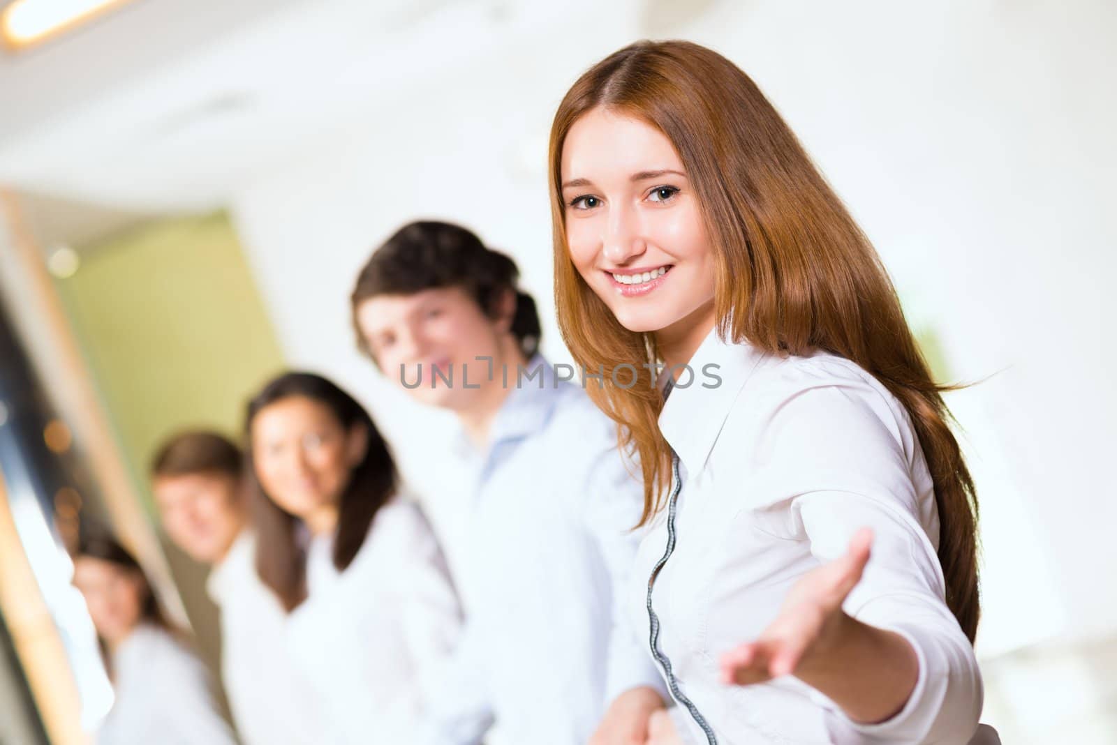 group of people holding hands, woman holds out her hand, the concept of teamwork