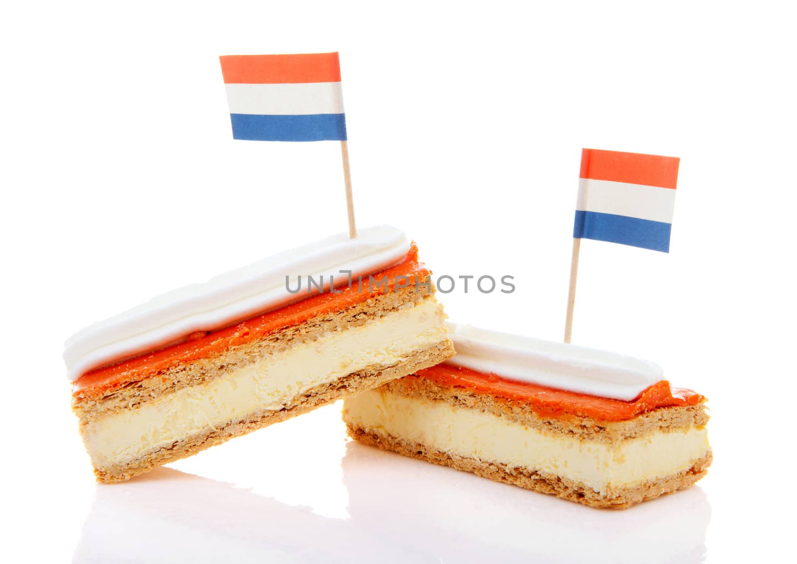 Two traditional Dutch pastry called tompouce  with flags over white background