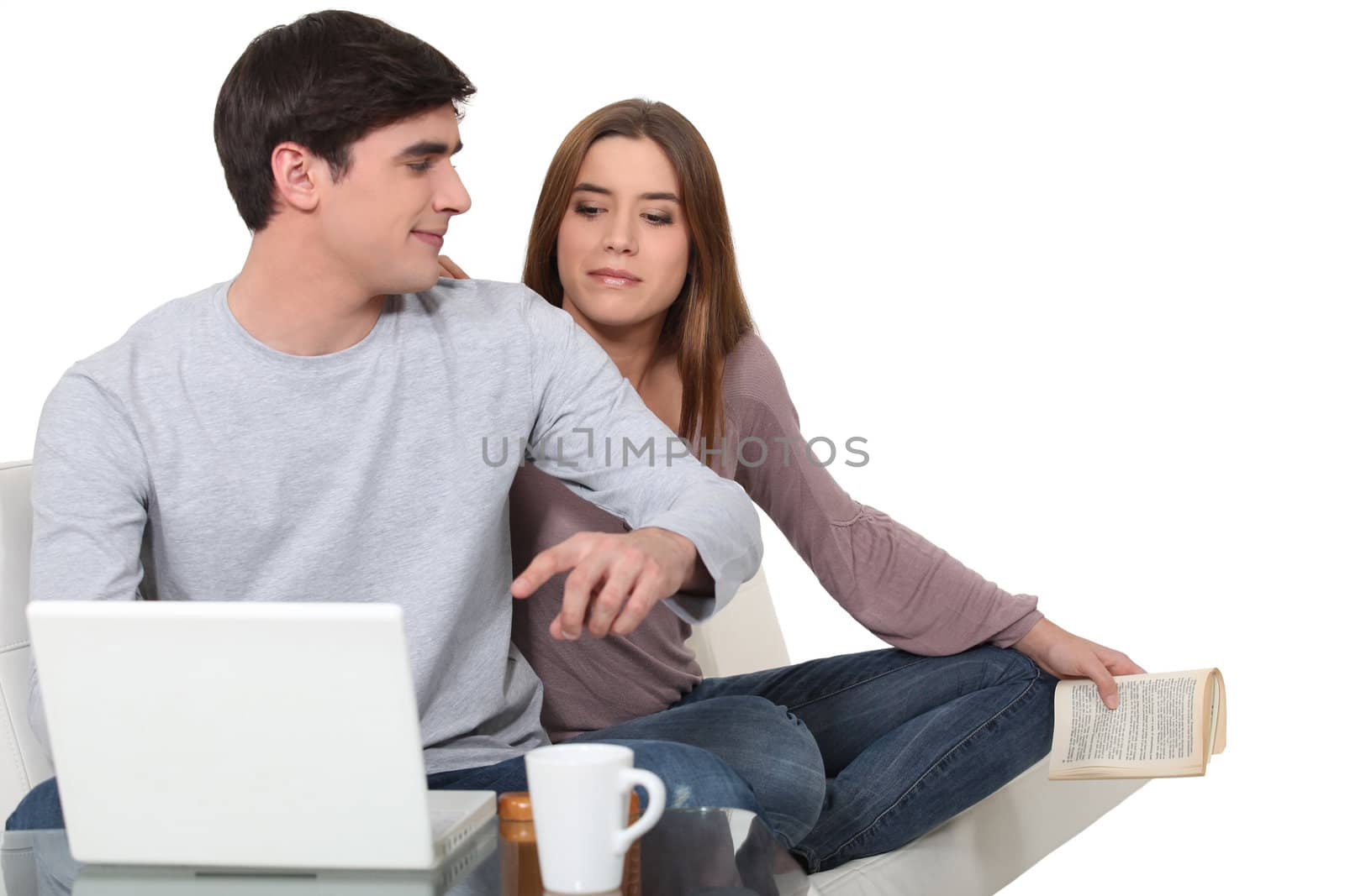 Young couple with laptop by phovoir