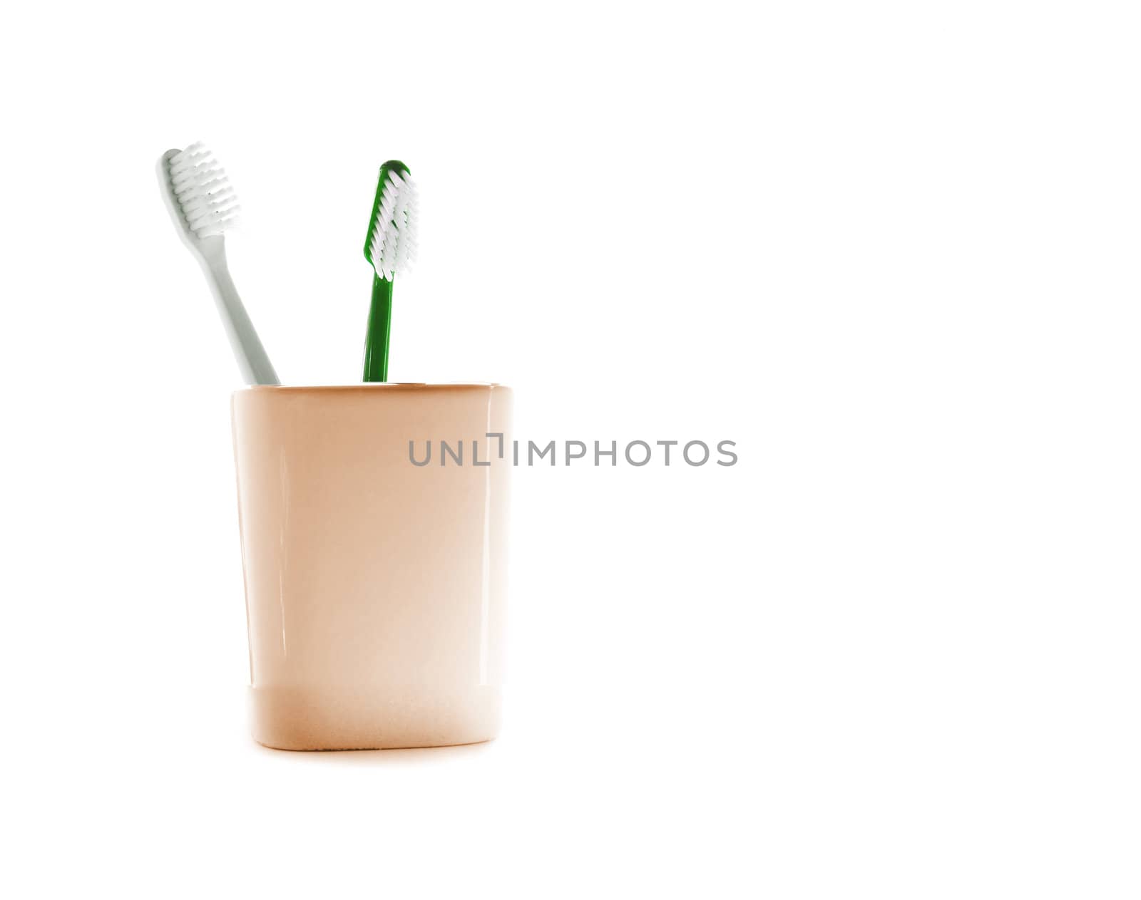 Two toothbrushes in glass