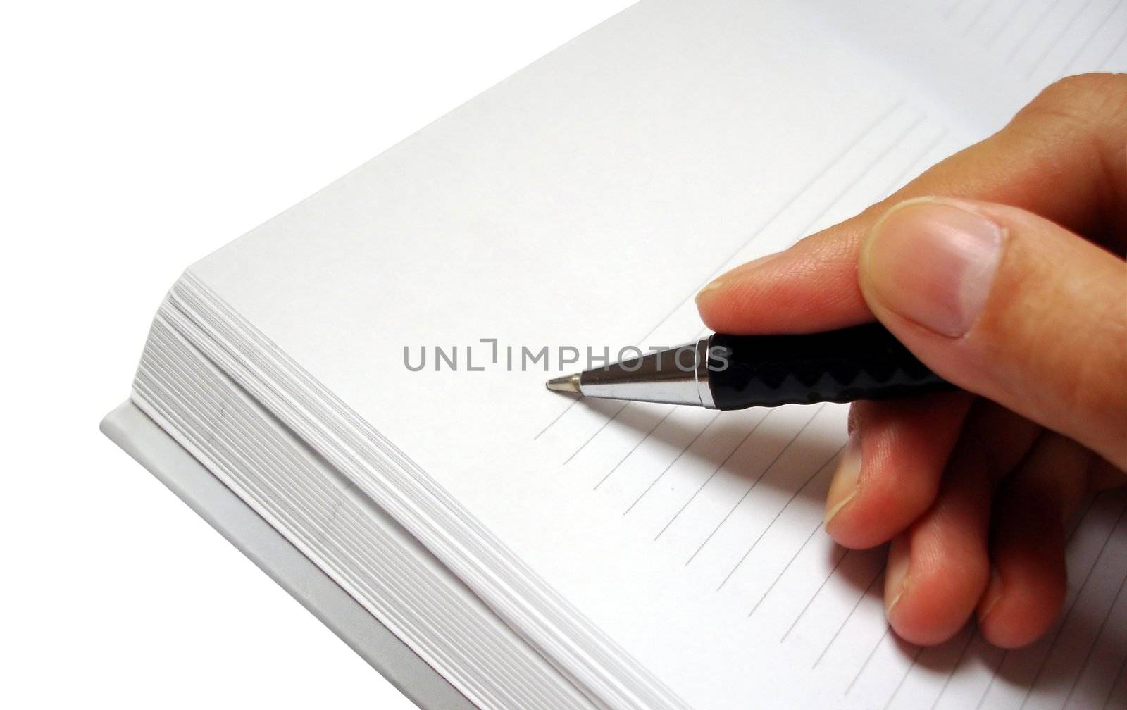 pen in hand writing on the notebook