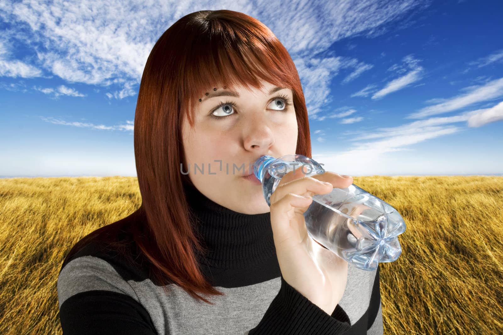 Redhead girl drinking water by domencolja