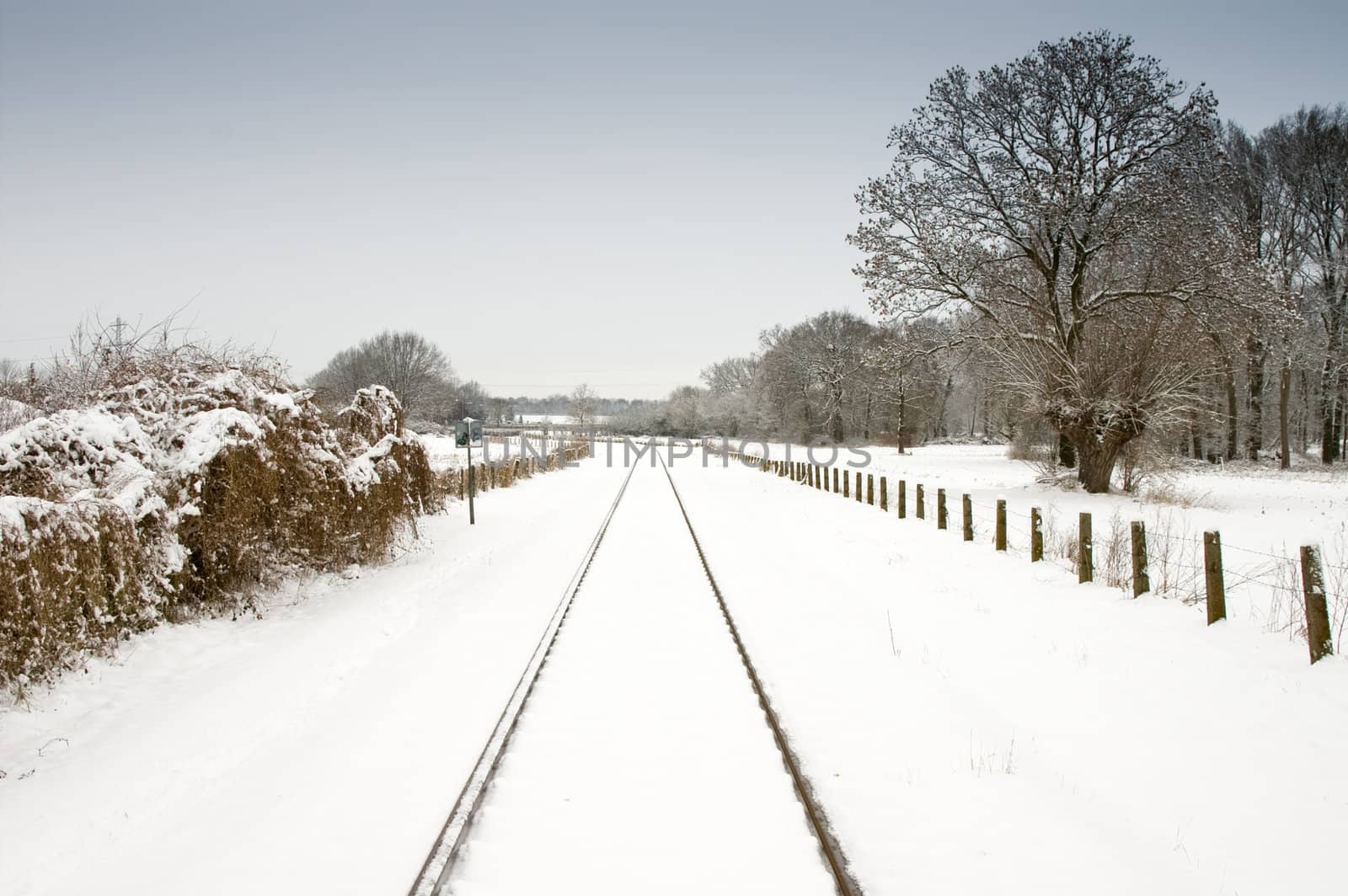 snow and railway with pale blue sky by karinclaus