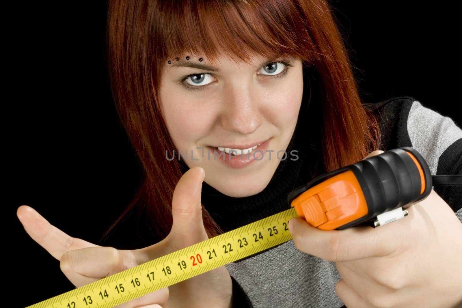 Redhead girl with measuring tool ruler by domencolja