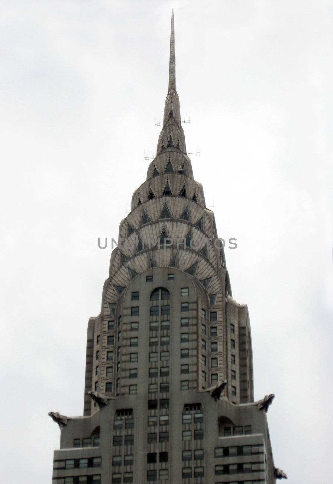 A closeup shot of the tip of a New York City skyscraper.