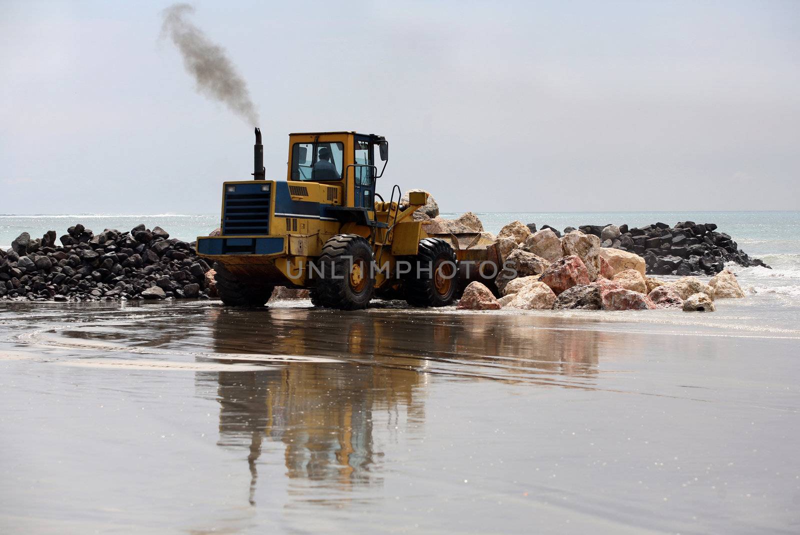 A view of a big bulldozer on coastline