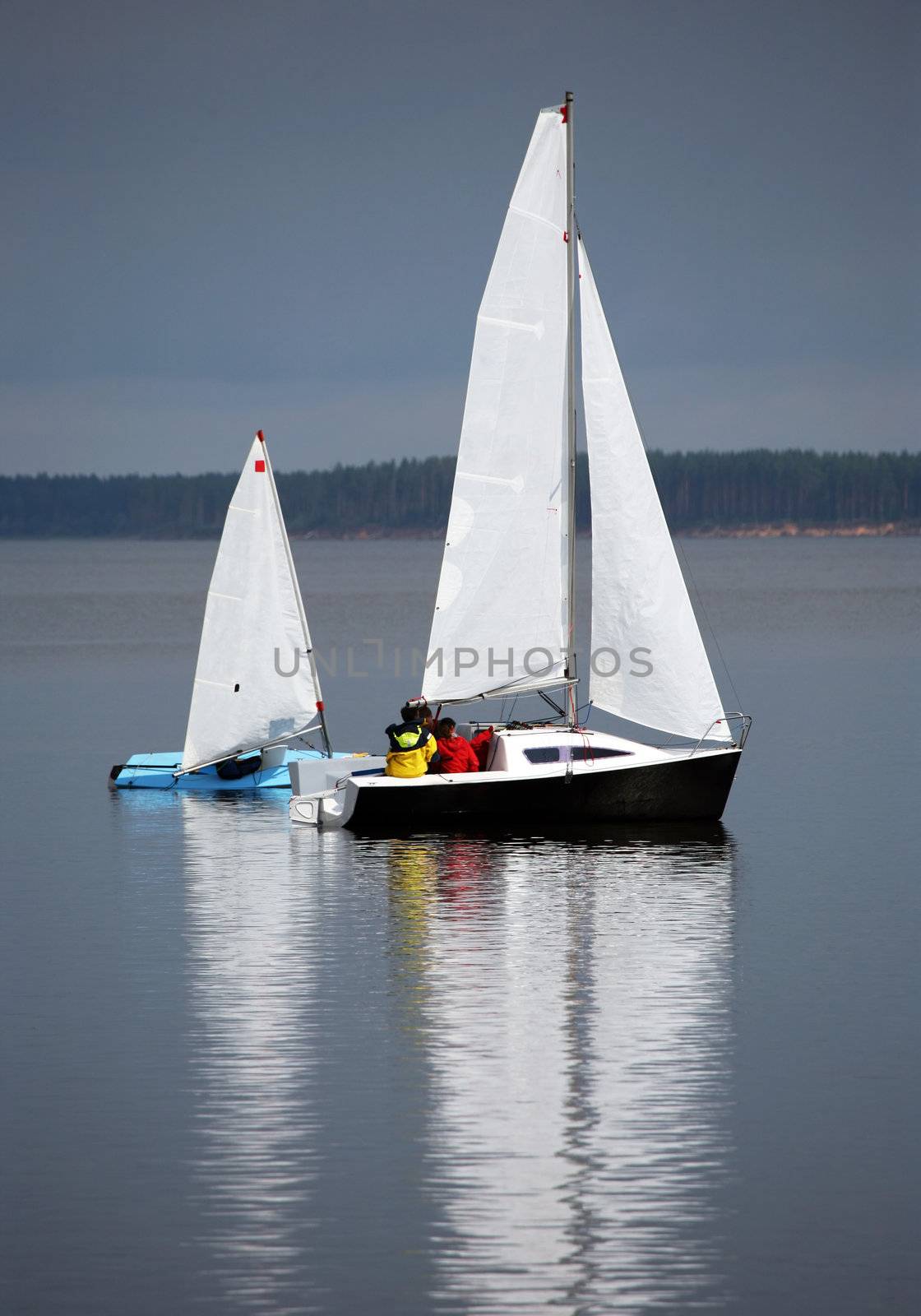 Two sailing boat at an open river. Russia