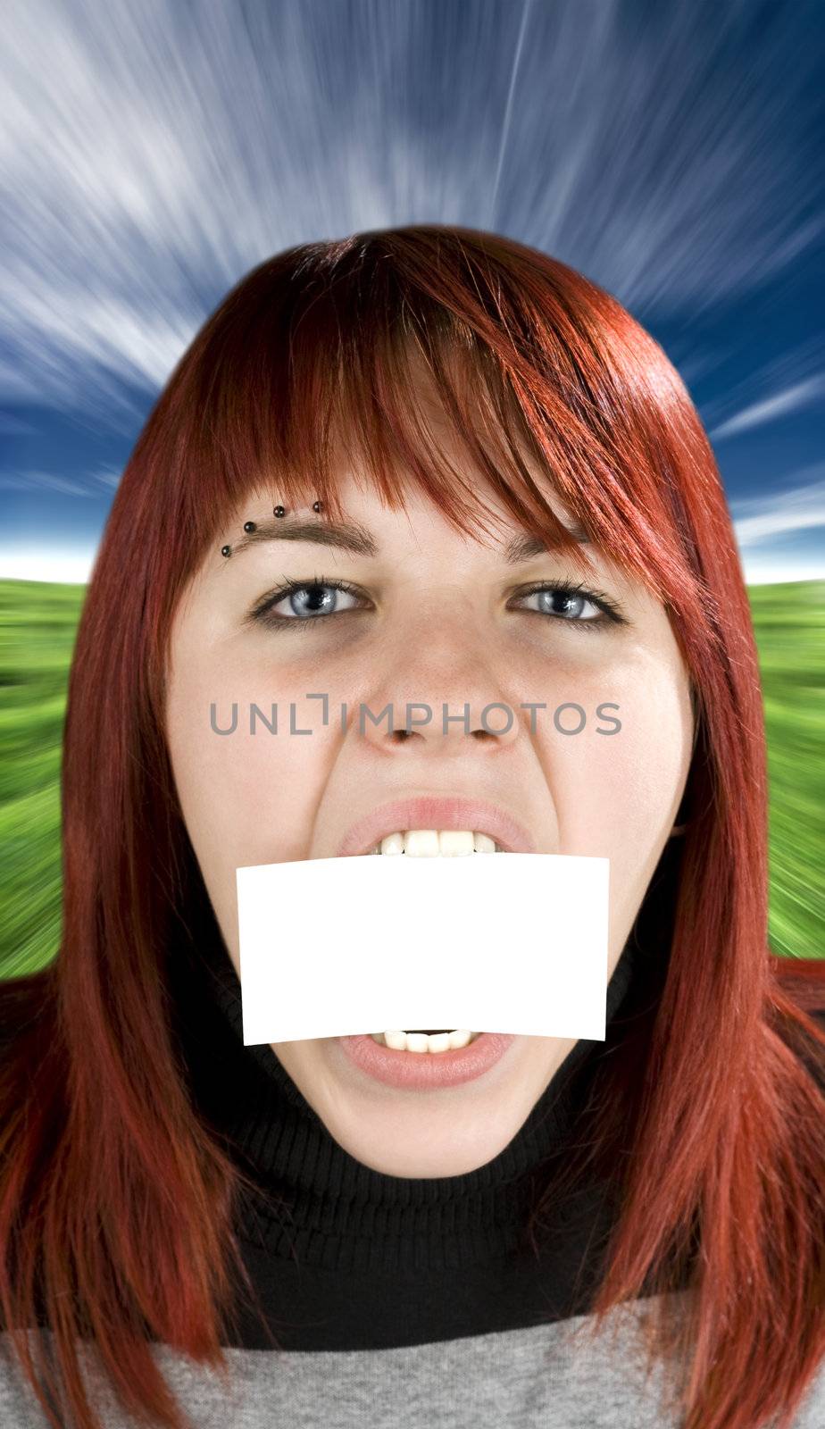 Redhead girl aggressively biting or eating a blank greeting card. Concept expresses nutrition or eating disorder problems.

Studio shot.

Studio shot.