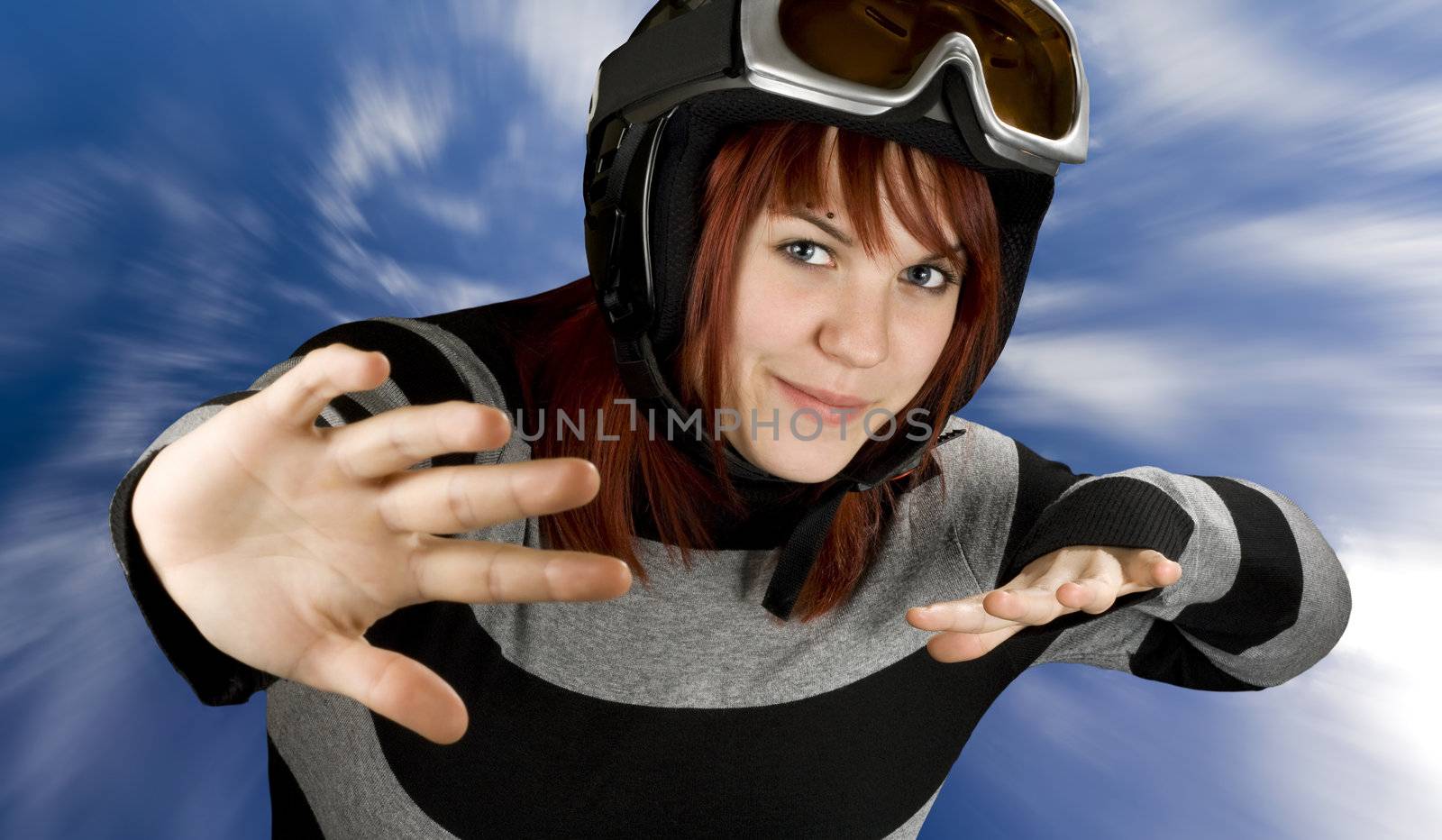 Cute girl freely snowboarding in a blue sky.

Studio shot, composite.