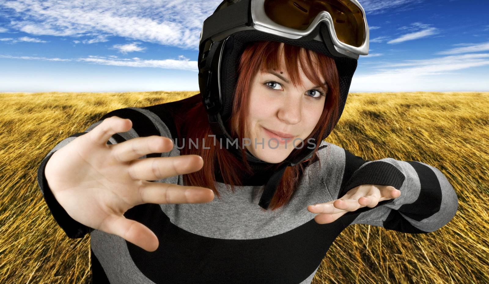 Cute girl freely snowboarding in a blue sky.

Studio shot, composite.