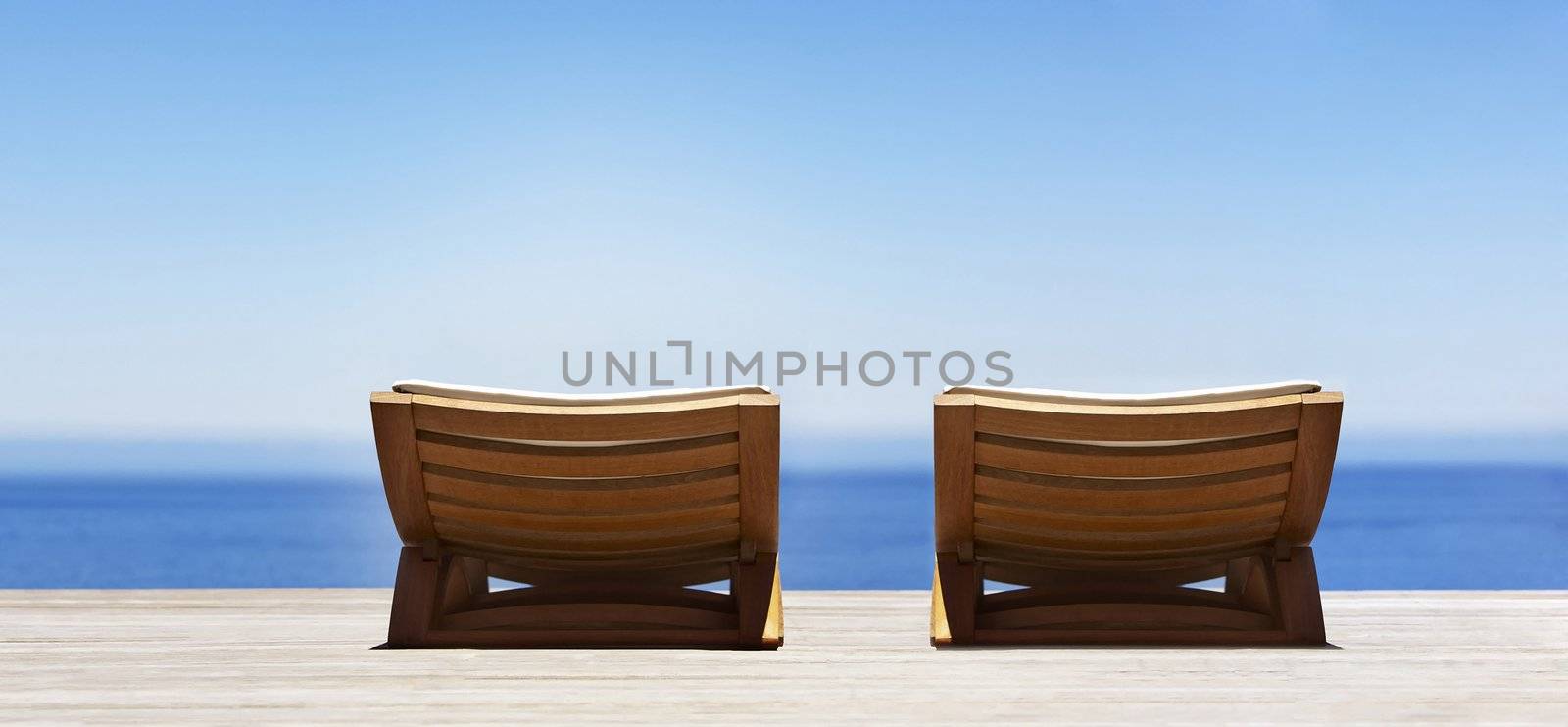 Beautiful beach with chaise lounge by ozaiachin