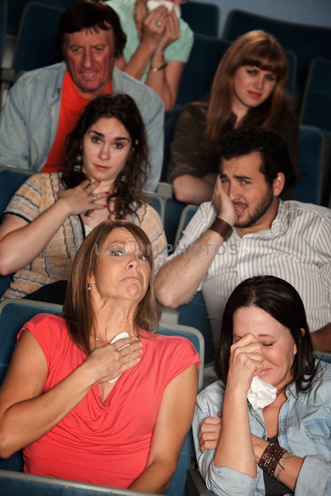 Group of 7 emotional male and female spectators weep