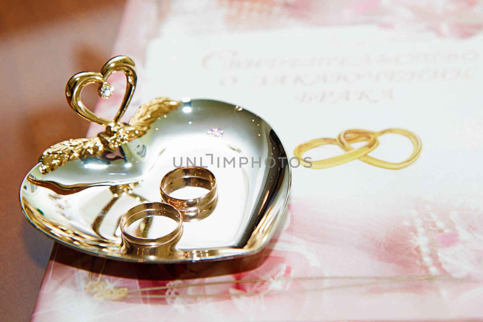 wedding rings and marriage certificate to the registration desk