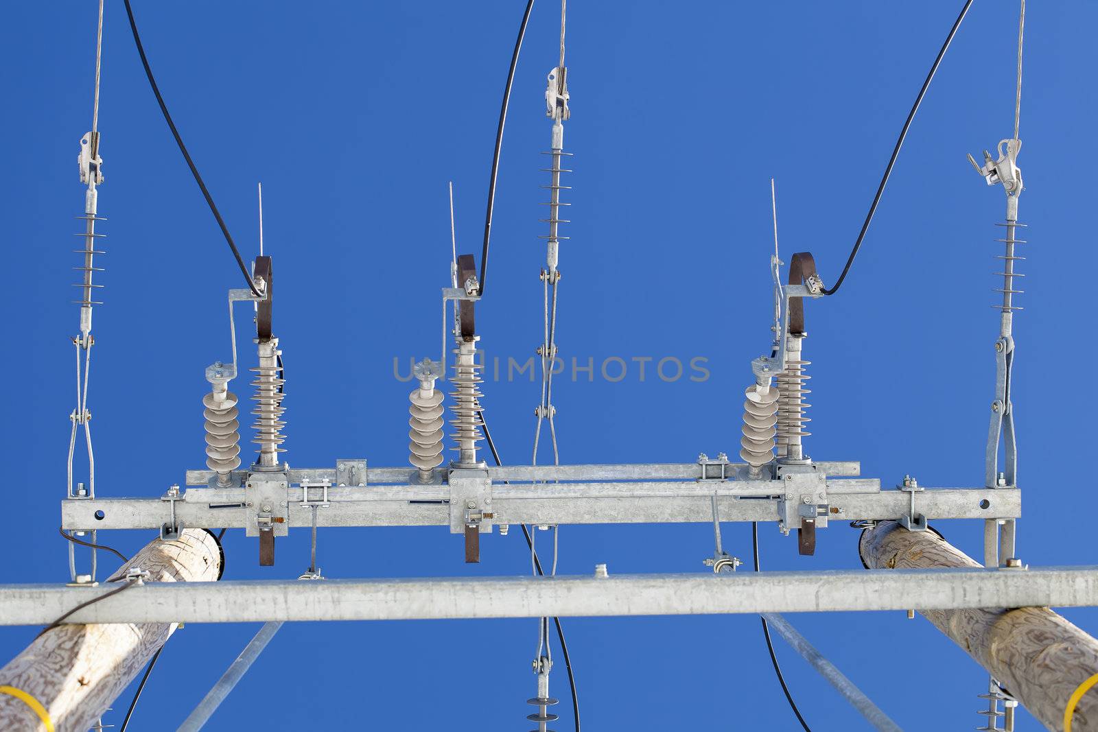 Electricity disconnector,insulators on a blue sky background by A.L.