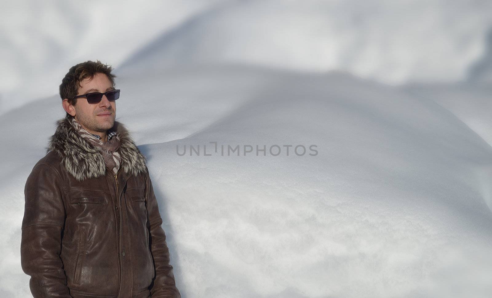 Good looking young man in front of snow. Copyspace, large space for text