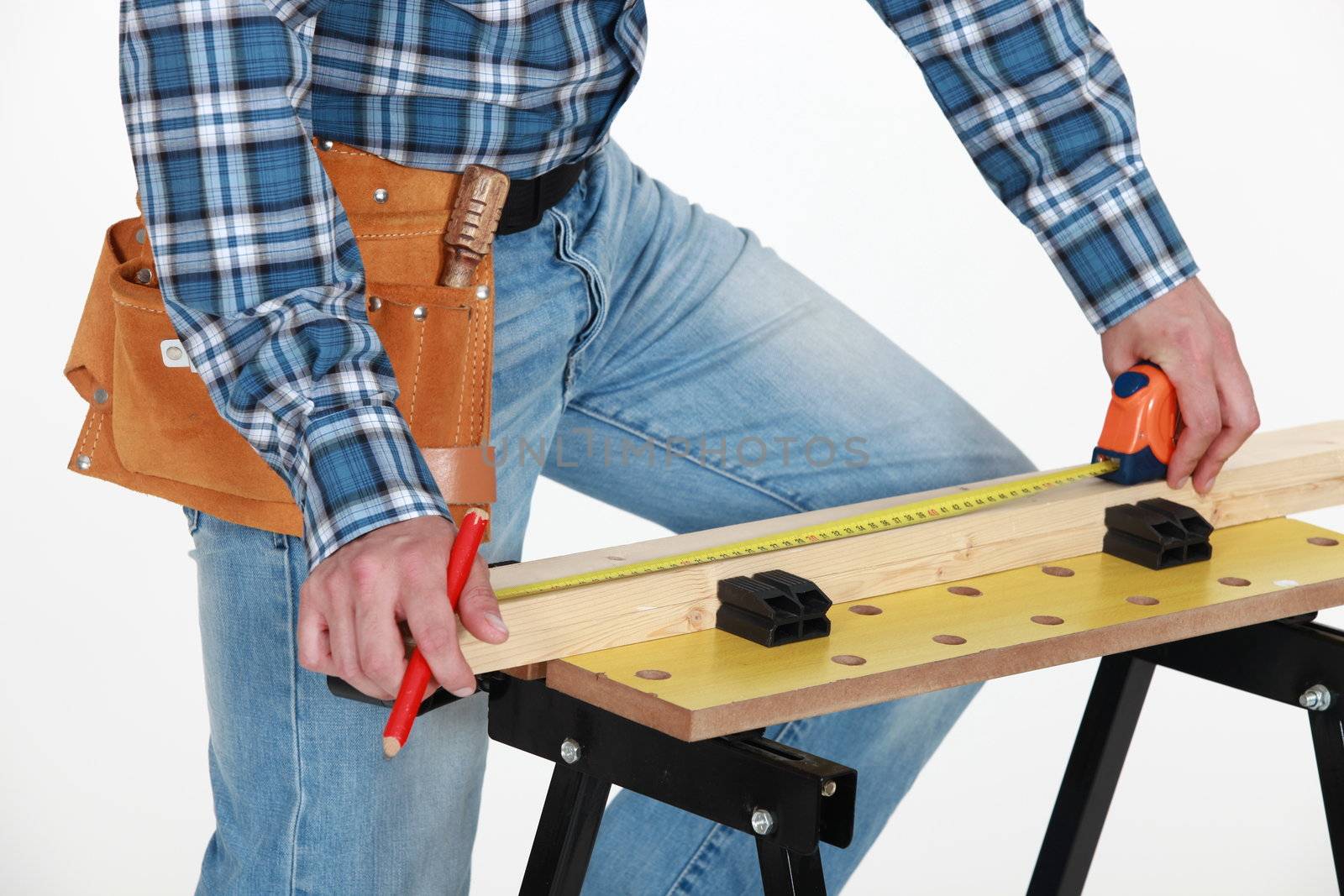 Carpenter measuring wood by phovoir