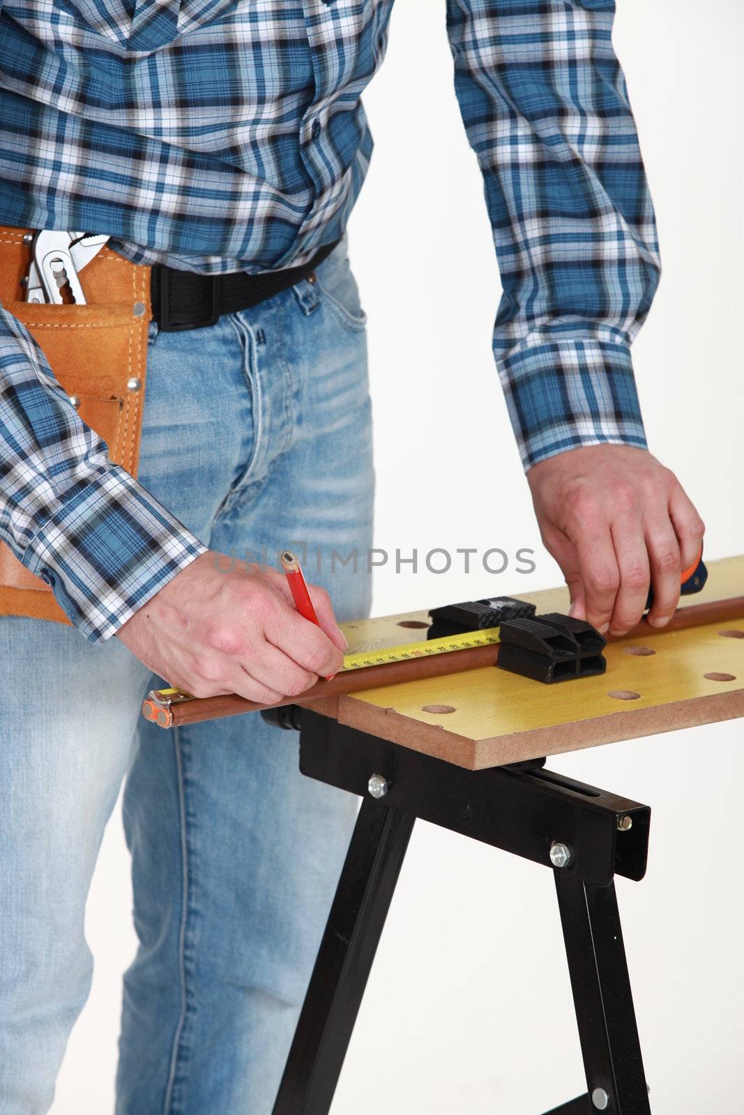 A carpenter taking measures.