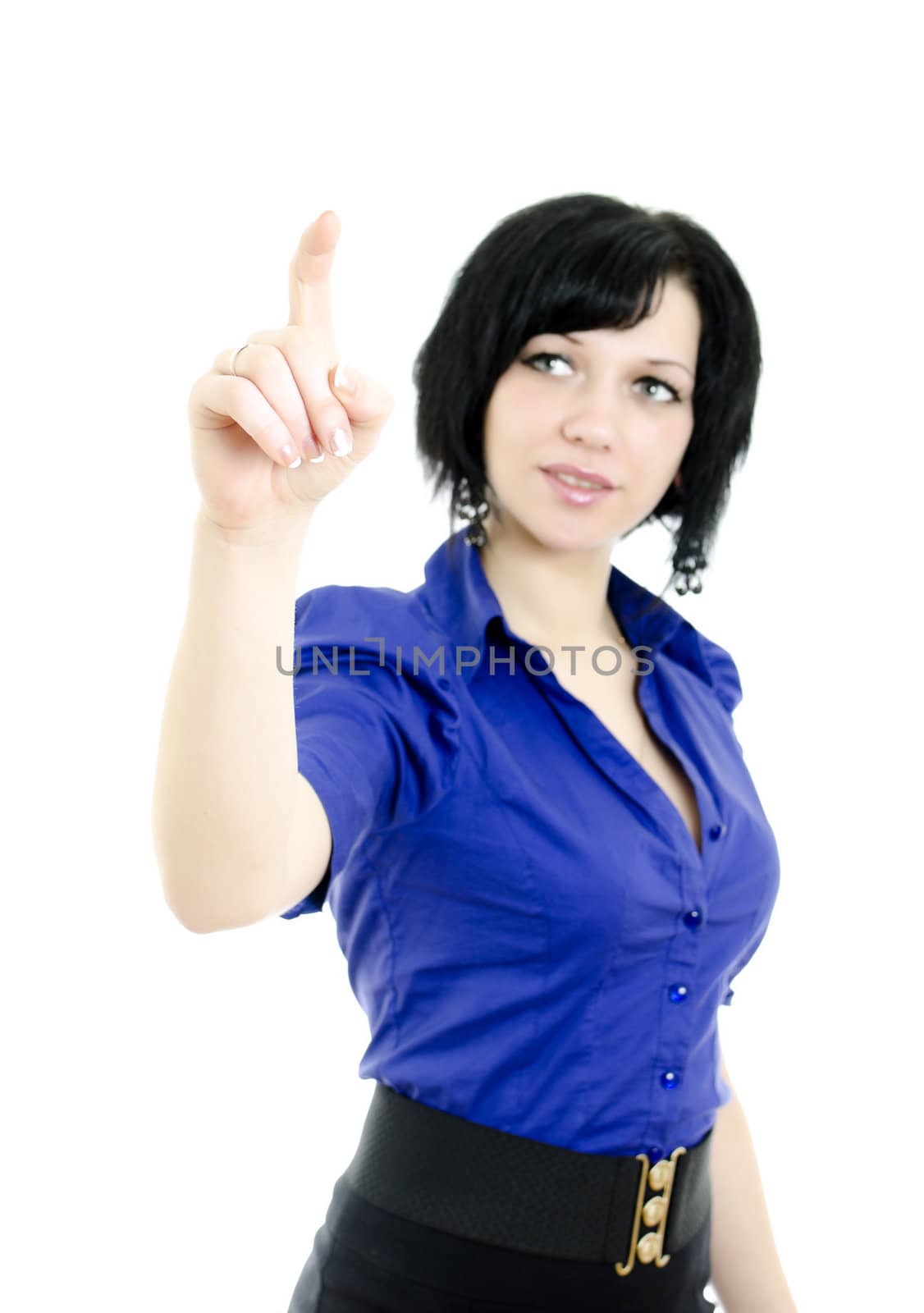 Portrait of a pretty young female pointing at copyspace. Isolated over white