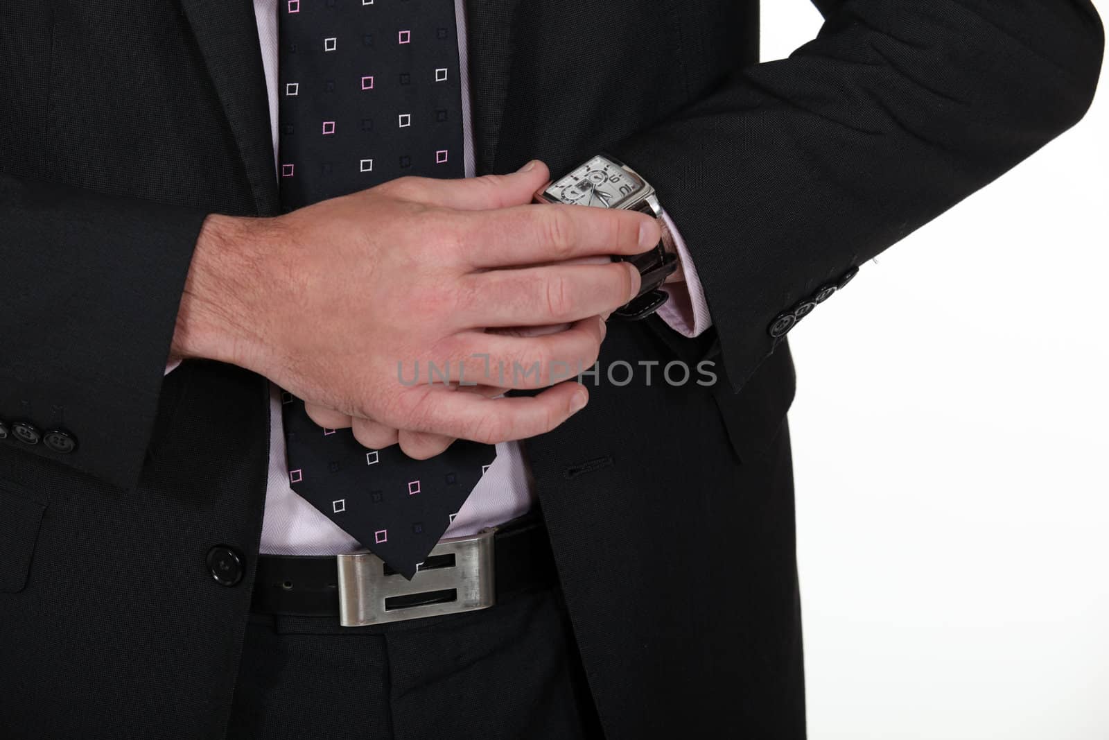 Businessman looking at the time by phovoir