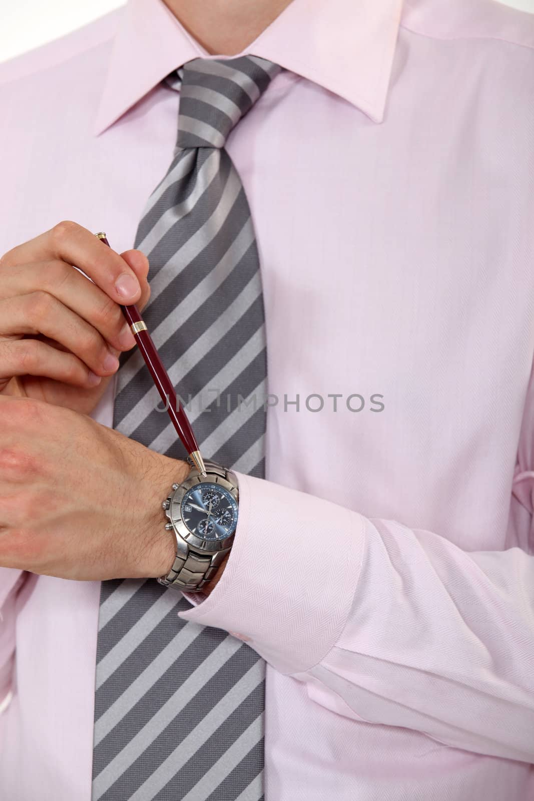 Businessman pointing at his watch.