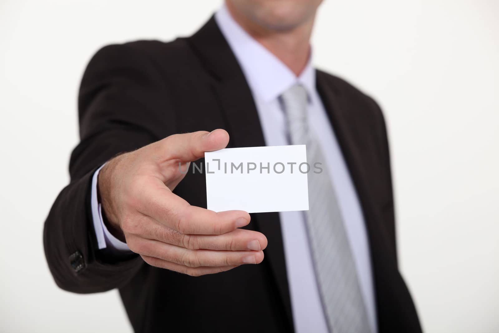 Man holding a blank business card by phovoir