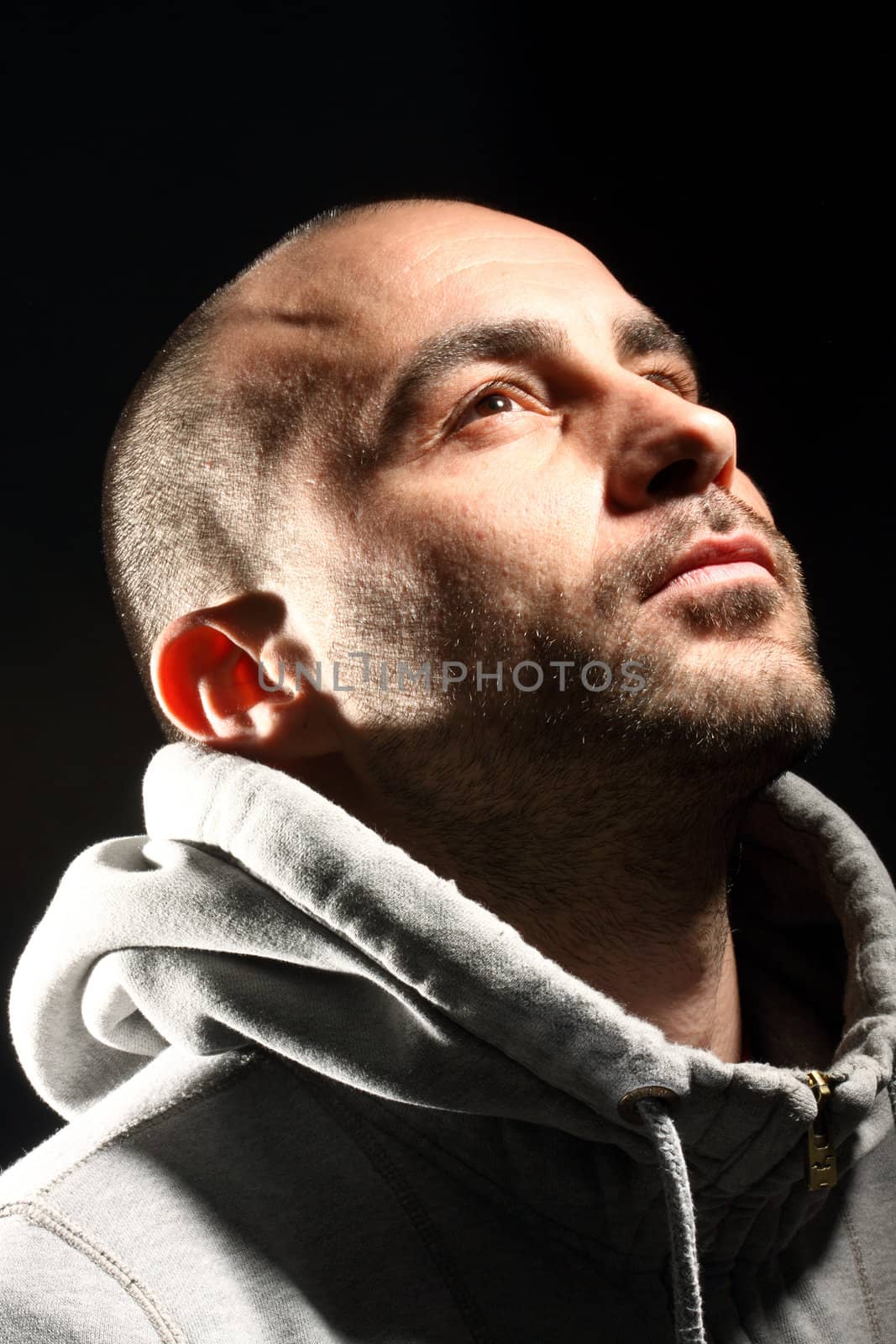 Portrait of a desperate young man on a black background