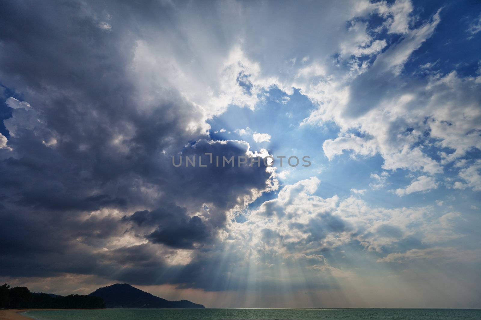 Cloudy sky over the sea with the sun - an evening landscape