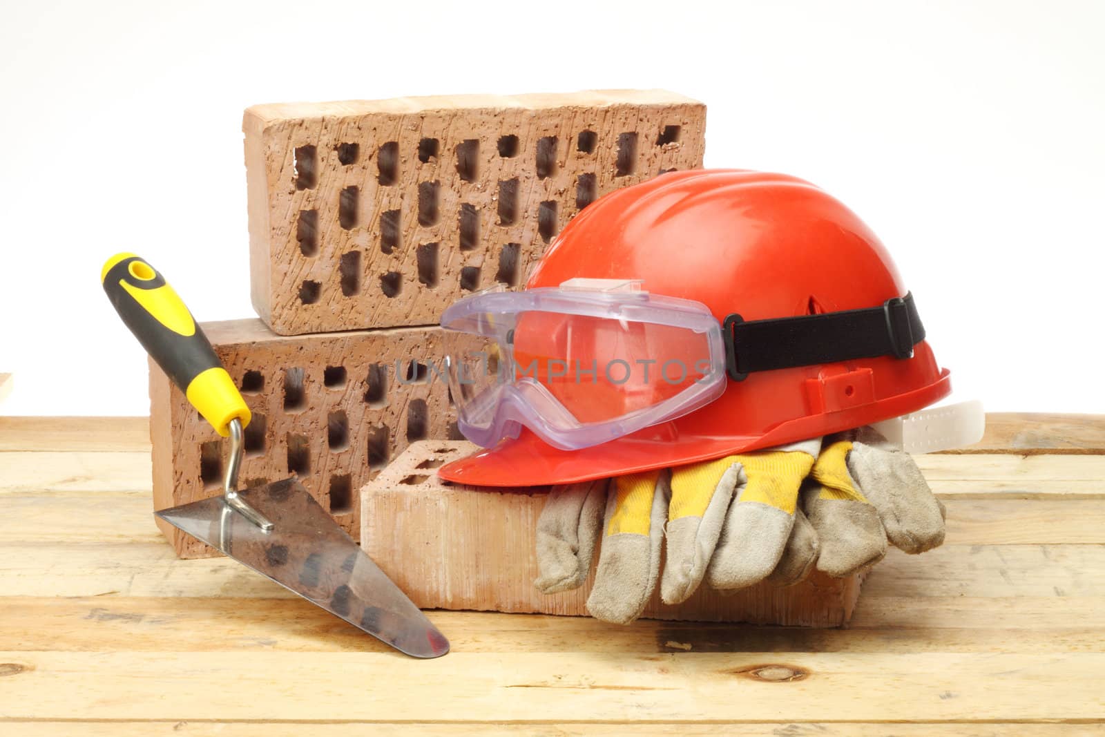 Bricks, trowel and helmet on work place