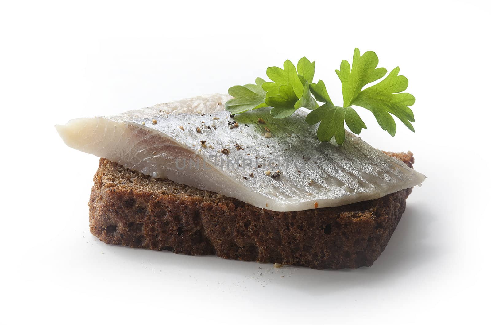 Sandwich with piece of herring, green parsley, onion and rye bread