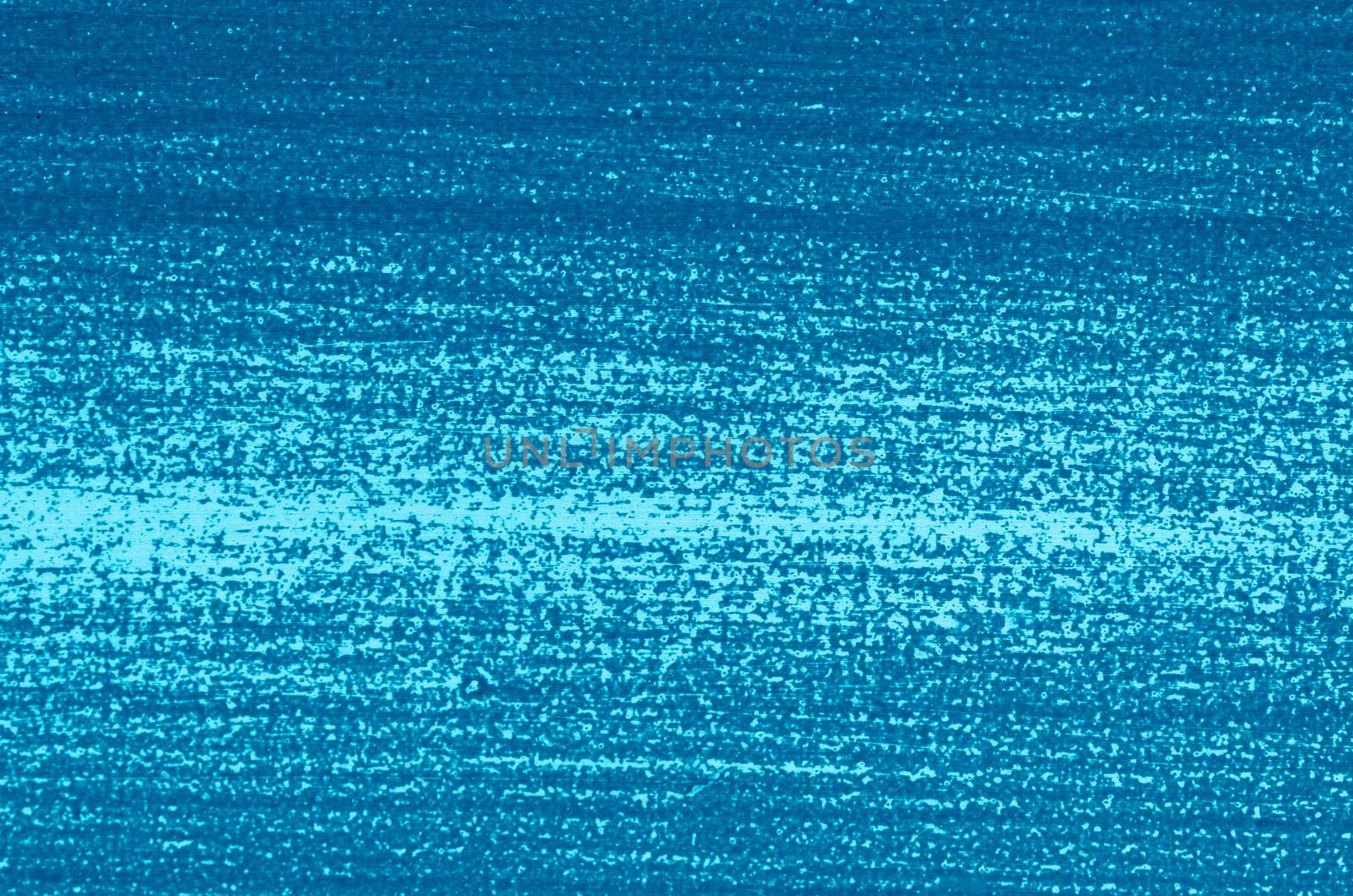 Close-up of part of  woodboard texture painted on blue.