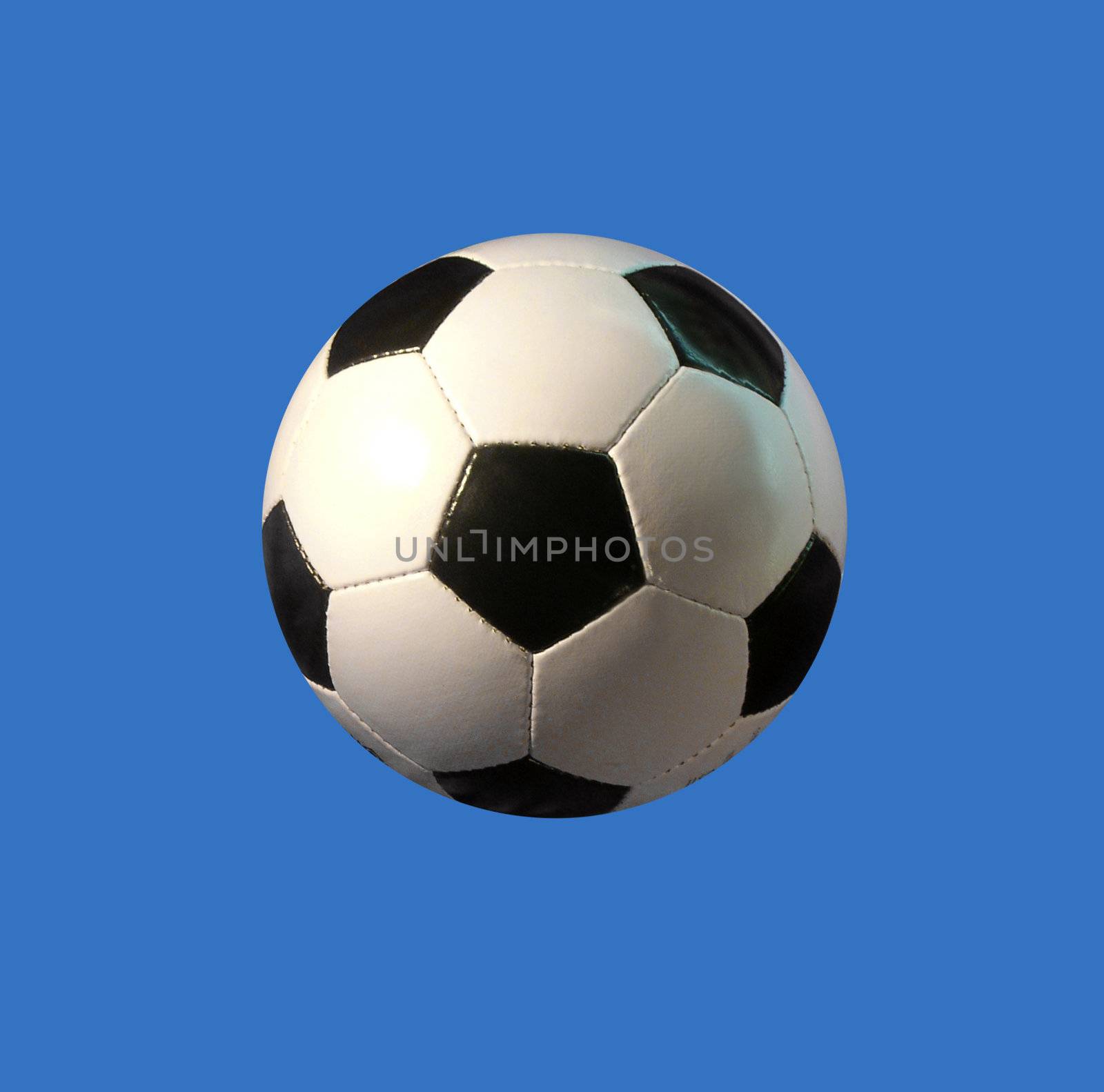 A simple soccer ball in front of clear blue background.