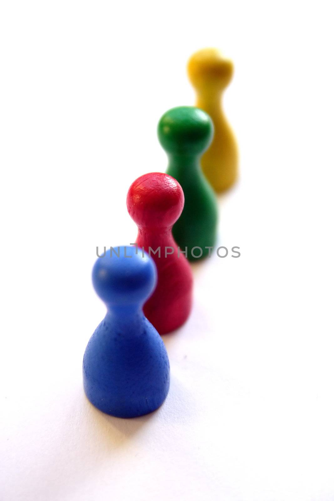 Some different coloured figures standing in one line. All isolated on white background.