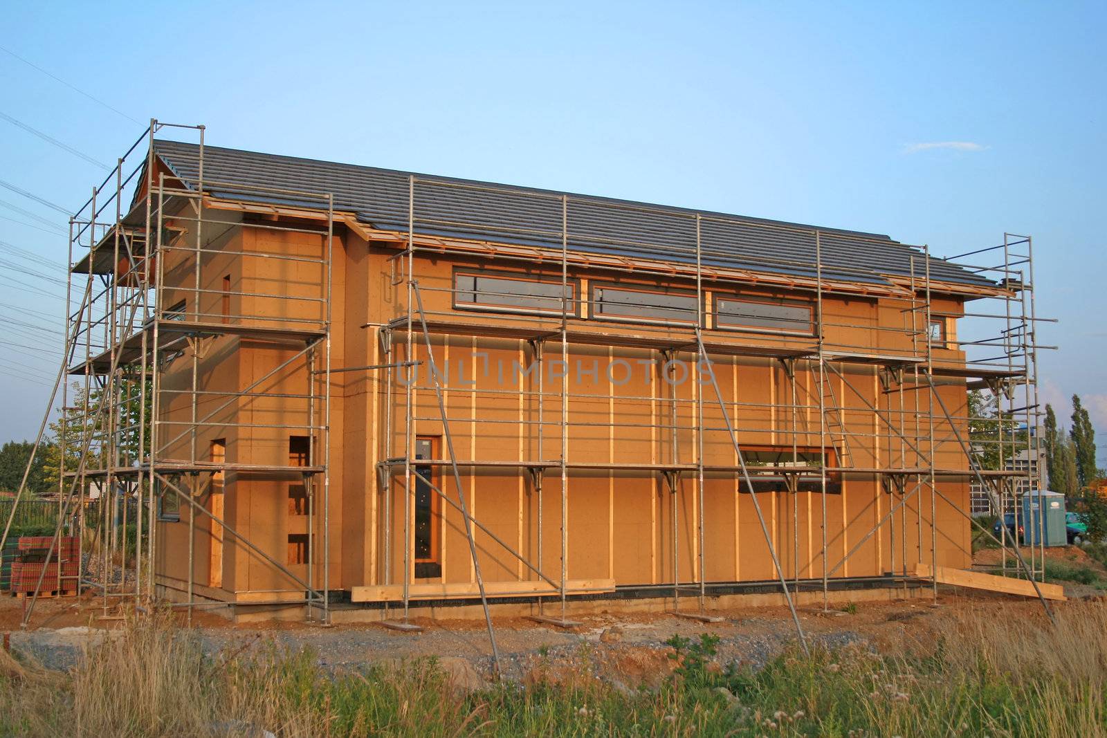 A typical building site during a bright sunset.