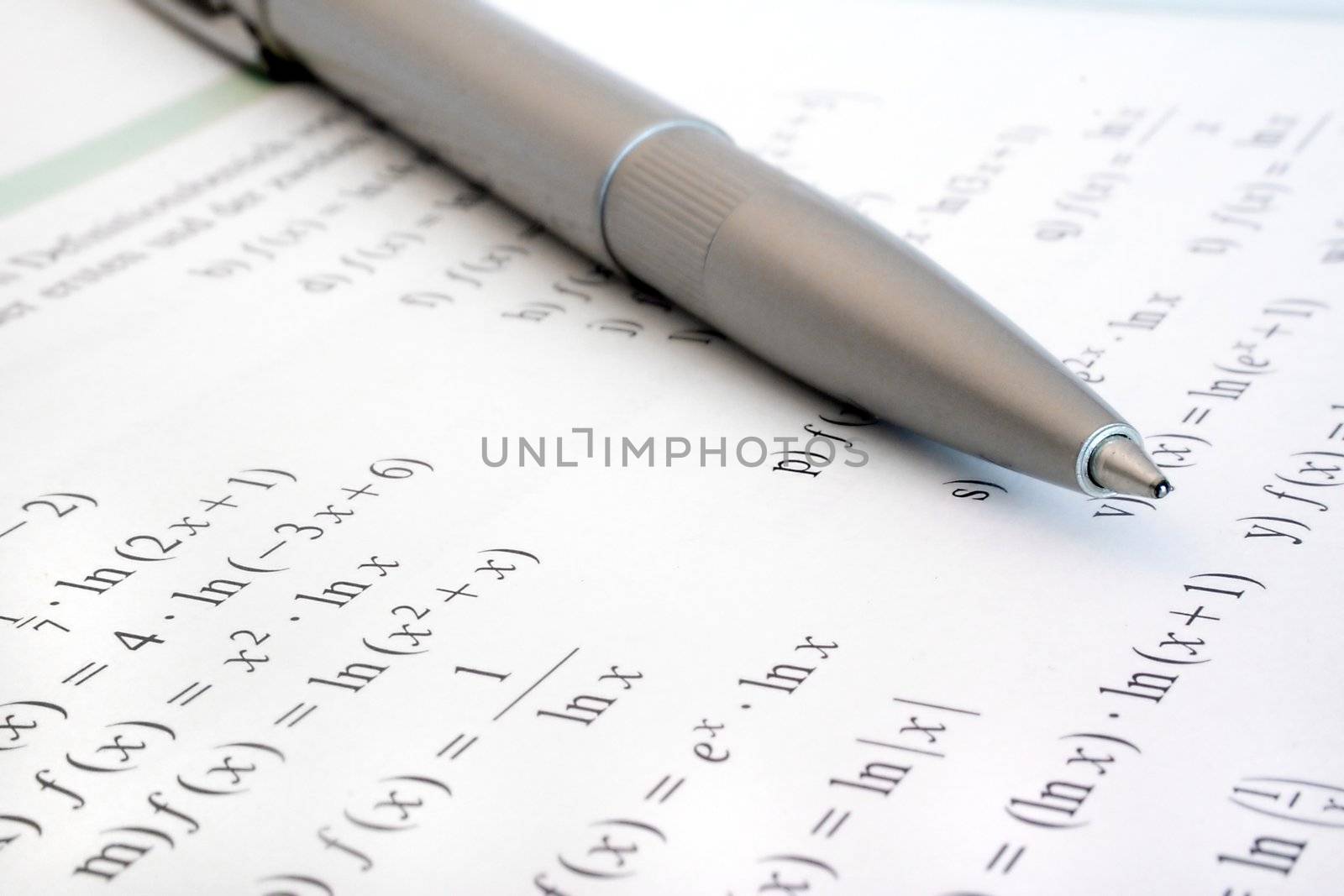 Some difficult formulas beside a silver biro.
** Note: Shallow depth of field.