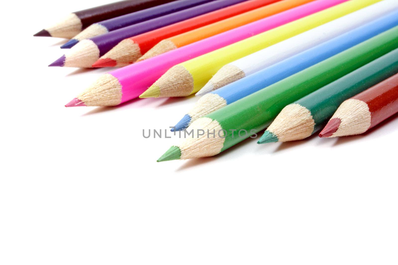 A line of colorful crayons. All isolated on white background.