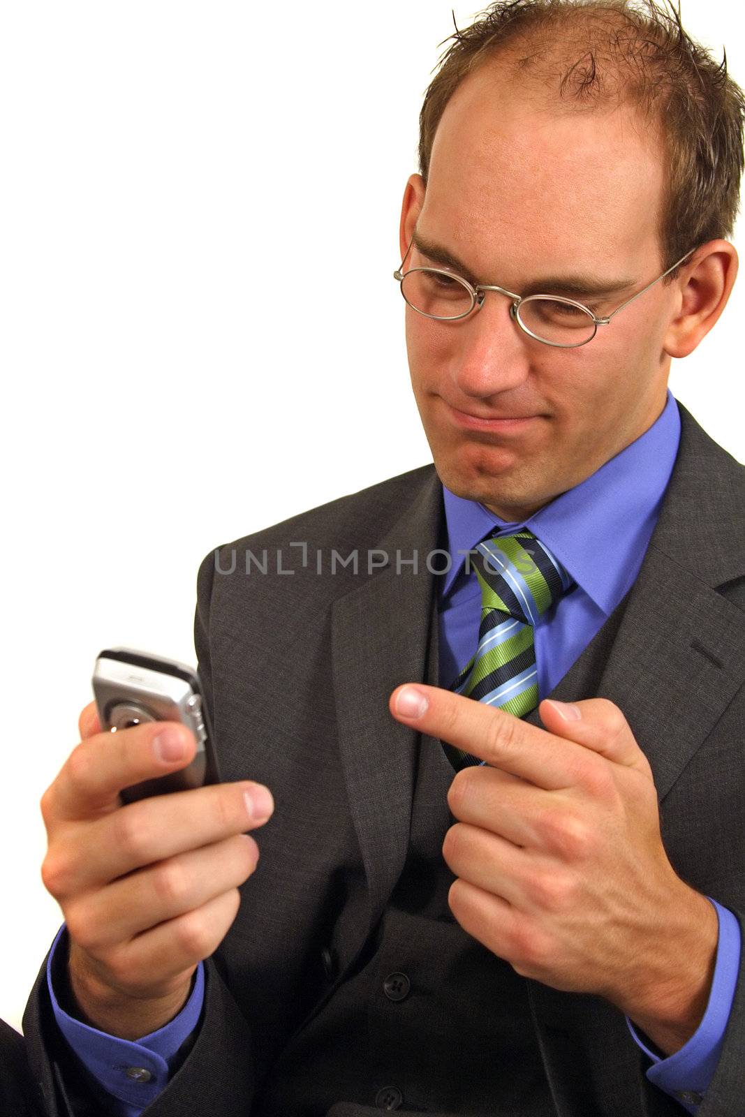 A smarting businessman gets bad news via his mobile phone. All isolated on white background.