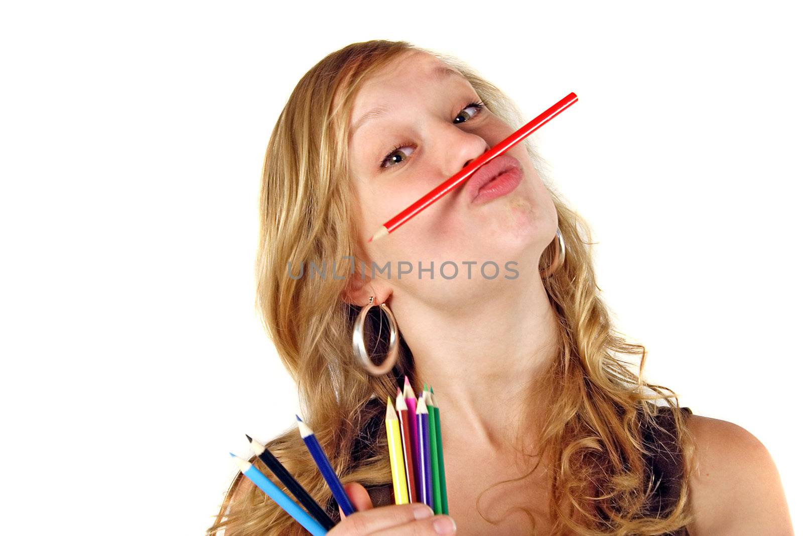 A young handsome woman playing with colored crayons. All isolated on white background.