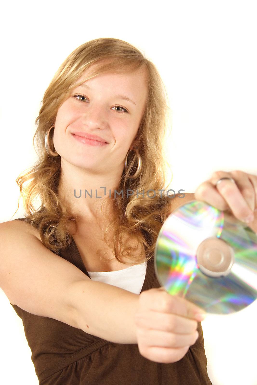 A young attractive girl smiling and holding a cd or dvd. All isolated on white background.
