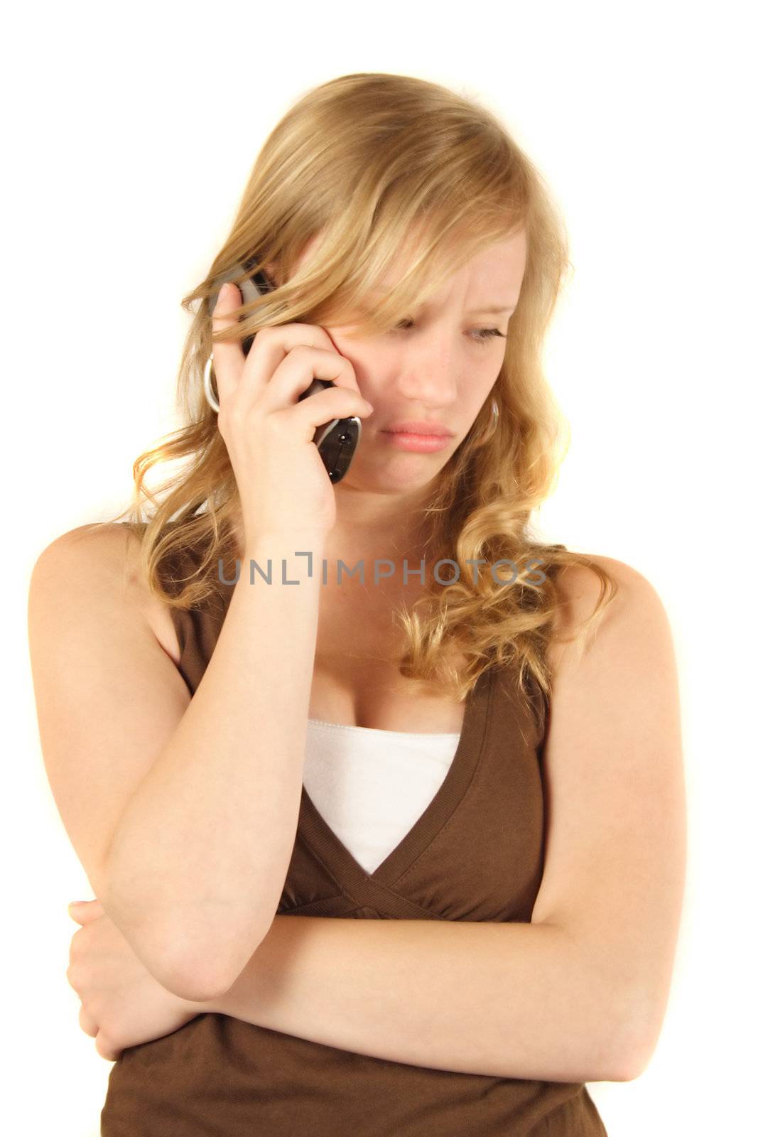 A young handsomewoman gets a disappointing call. All isolated on white background.