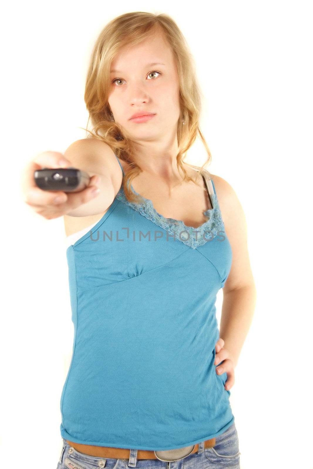 A young handsome woman using a remote control. All isolated on white background.