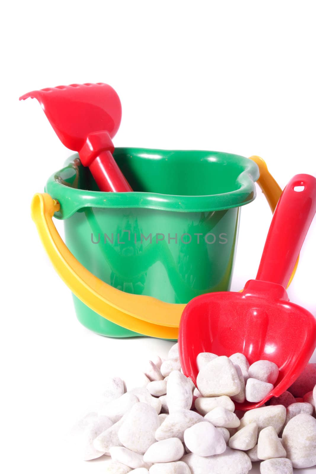 Bucket and shovel of a child. All isolated on white background.