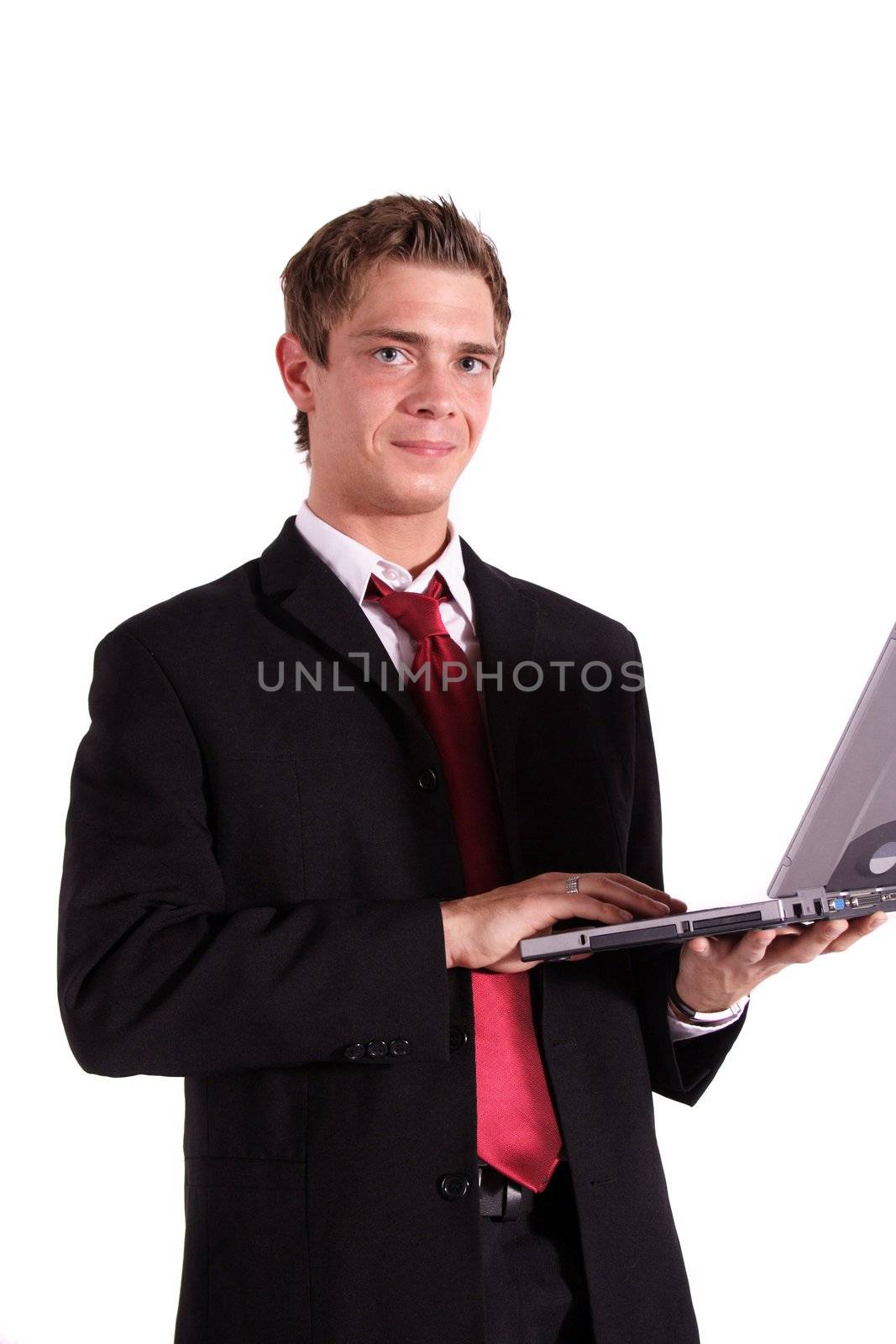 A motivated businessman working on his notebook computer. All isolated on white background.