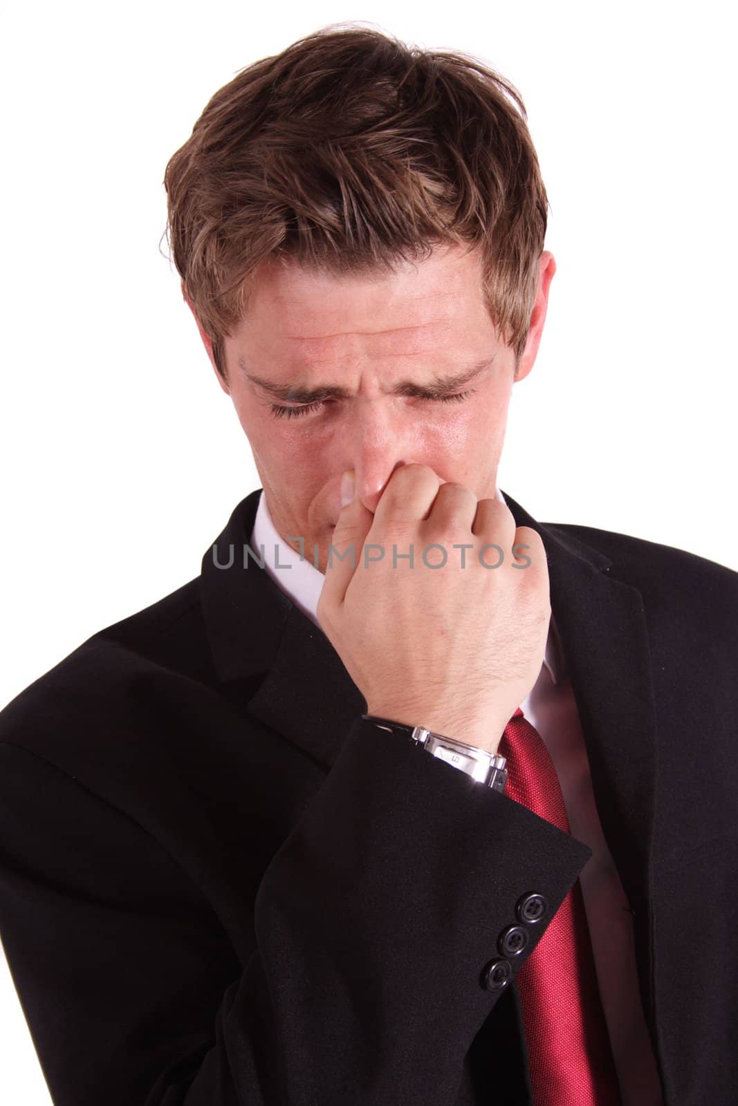 A handsome businessman smells something stinky. All isolated on white background.