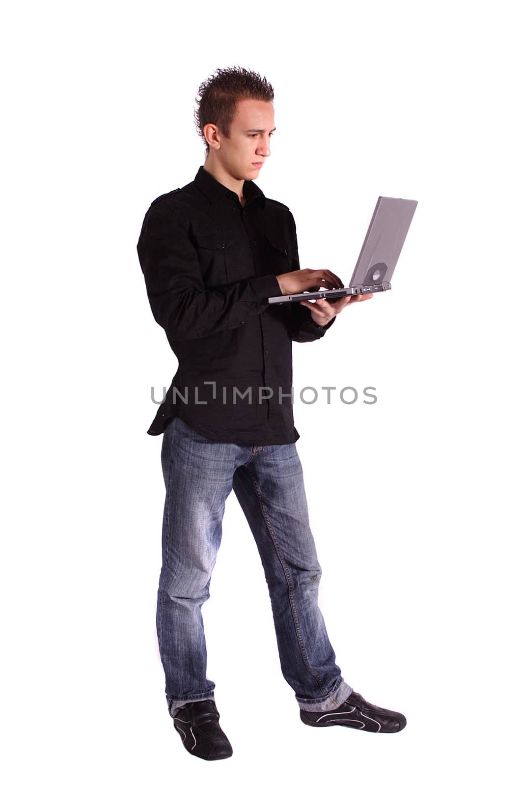 A young handsome man surfing the internet with his notebook computer. All isolated on white background.